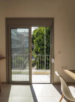 an open door with a view of a balcony at Trinity Urban Residences Plumeria in Rhodes Town