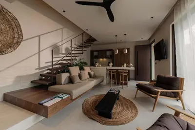 a living room with a couch and a stair case at Terra Mare Villas in Ialyssos