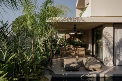 a patio with a bed and a table and some plants at Terra Mare Villas in Ialyssos