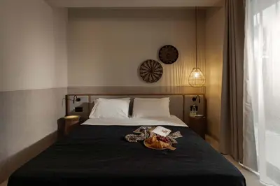 a bedroom with a bed with a clock on the wall at Terra Mare Villas in Ialyssos