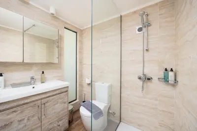 a bathroom with a toilet and a glass shower at Villa Elena in Kalathos