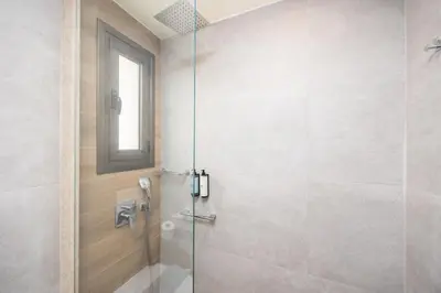 a bathroom with a shower with a glass door at Villa Elena in Kalathos