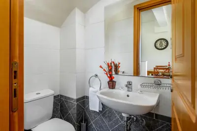 a white bathroom with a toilet and a sink at Villa Daphne in Kalathos