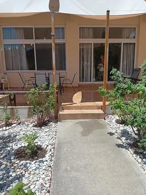 a house with a porch and a patio at Giulia's Beach House in Rhodes Town