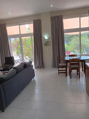 a living room with a couch and a table at Giulia's Beach House in Rhodes Town