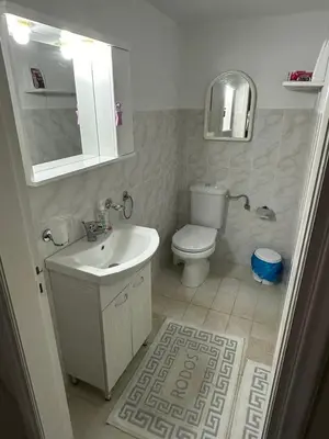 a bathroom with a toilet and a sink at Giulia's Beach House in Rhodes Town