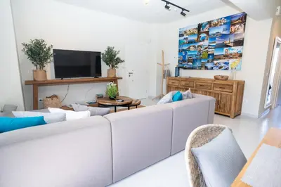 a living room with a white couch and a tv at FeWo Traum auf Rhodos in Rhodes Town
