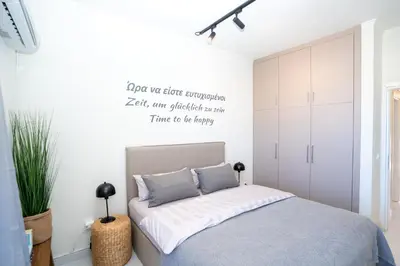 a bedroom with a bed with a quote on the wall at FeWo Traum auf Rhodos in Rhodes Town