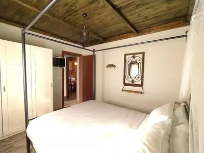 a bedroom with a white bed and a mirror at Rustic House Smaro in Émbonas