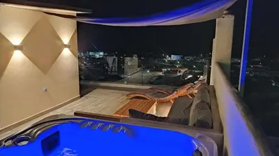 a jacuzzi in a room with a view of the city at Rustic House Smaro in Émbonas