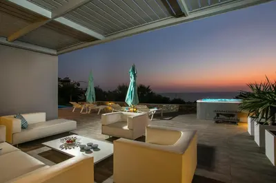 a living room with couches and a patio at Villa Lily in Pefki Rhodes
