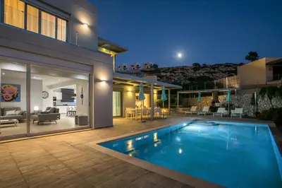 a house with a swimming pool in the backyard at Villa Lily in Pefki Rhodes