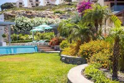 a garden with a swimming pool and some plants at Villa Lily in Pefki Rhodes