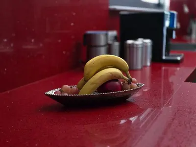 a bowl of fruit with bananas and apples on a counter at Villa Aurelia Privat Pool in Kolimbia