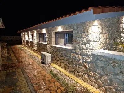 a stone building with a tv on the side of it at Villa Aurelia Privat Pool in Kolimbia
