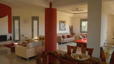 a living room with a couch and a table at Villa Artemis in Koskinou