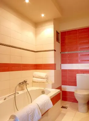 a bathroom with a tub and a toilet at Villa Artemis in Koskinou