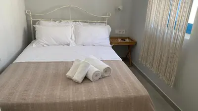 a bedroom with a bed with two towels on it at FEDON Guesthouse in Halki