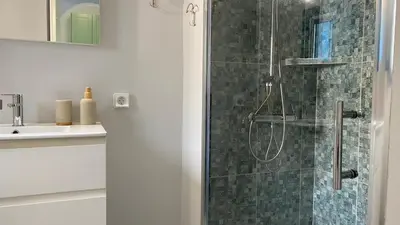 a bathroom with a shower with a glass door at FEDON Guesthouse in Halki