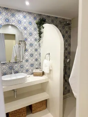 a bathroom with a sink and a mirror at Álas Holiday Home in Archangelos
