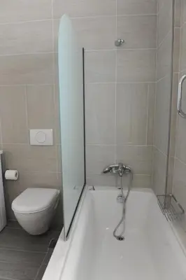 a bathroom with a shower and a toilet and a tub at Gennadi Aegean Horizon Villas in Gennadi