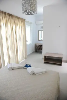 a bedroom with a bed with two towels on it at Gennadi Aegean Horizon Villas in Gennadi