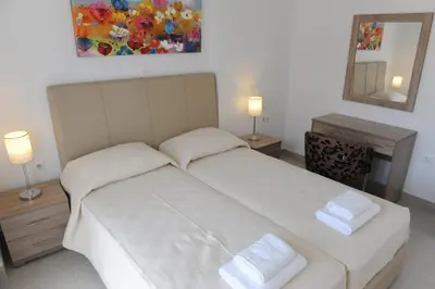 a bedroom with a bed with two white towels on it at Gennadi Aegean Horizon Villas in Gennadi