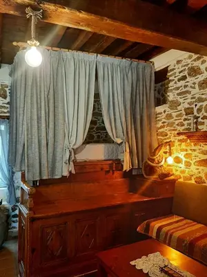 a room with a window with a couch and a table at Apollon Traditional House in Apóllona