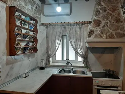 a kitchen with a sink and a window at Apollon Traditional House in Apóllona