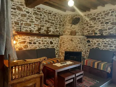 a living room with a couch and a table at Apollon Traditional House in Apóllona