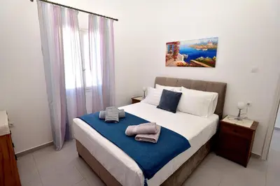 a bedroom with a large bed with towels on it at Athina's house in Archangelos