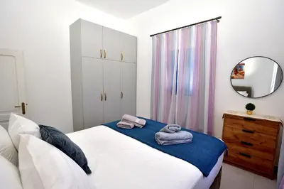 a bedroom with a bed with towels on it at Athina's house in Archangelos