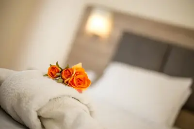a bouquet of orange roses sitting on top of a towel at Patricia Suites in Faliraki