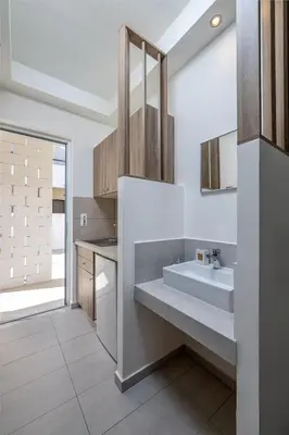 a bathroom with a sink and a mirror at Patricia Suites in Faliraki