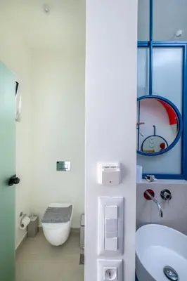 a white bathroom with a sink and a toilet at Patricia Suites in Faliraki