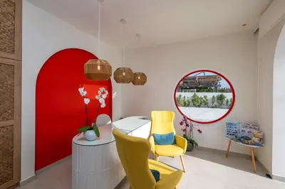 a room with a table and chairs and a mirror at Patricia Suites in Faliraki