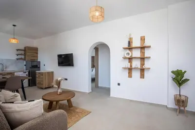 a living room with a couch and a table at Zaia Suites & Living , Suite N6 , sea side view in Gennadi