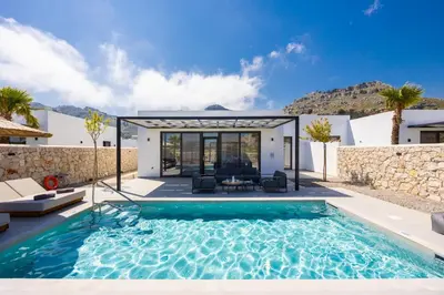 a swimming pool in a villa with a house at Villa 13 Zendo in Kolimbia