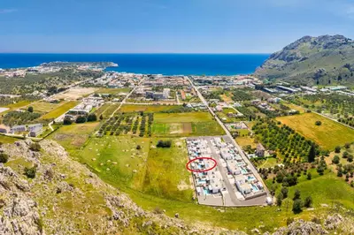 an aerial view of a parking lot next to the ocean at Villa 12 Chado in Kolimbia