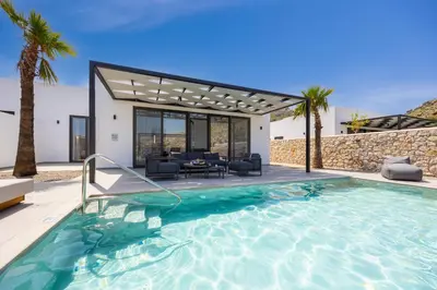 a villa with a swimming pool and a house at Villa 12 Chado in Kolimbia