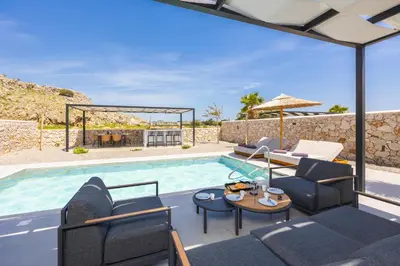 a villa with a swimming pool and a patio at Villa 12 Chado in Kolimbia
