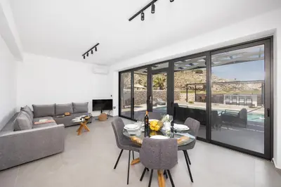 a living room with a table and a couch at Villa 12 Chado in Kolimbia