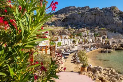 a beach with a bunch of buildings and flowers at Villa 12 Chado in Kolimbia