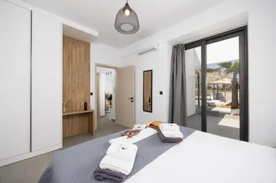 a bedroom with a large bed with towels on it at Villa 10 Hozan in Kolimbia