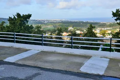 a white fence with a view of a city at Aikaterini Lever Du Soleil Apart, Koskinou in Koskinou