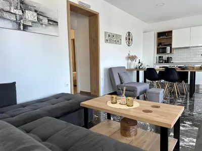 a living room with a couch and a table at Aikaterini Lever Du Soleil Apart, Koskinou in Koskinou