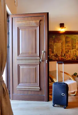 a door with a suitcase in front of a room at Unique Smaragda's Residense in Rhodes Town