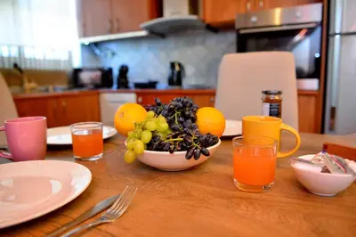 a table with a bowl of fruit on top of it at Unique Smaragda's Residense in Rhodes Town