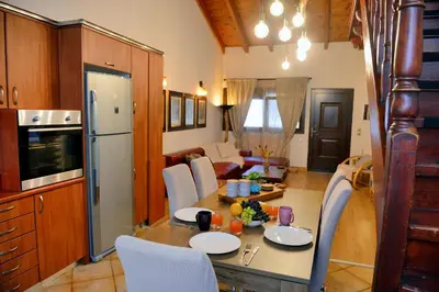 a kitchen and living room with a table and chairs at Unique Smaragda's Residense in Rhodes Town