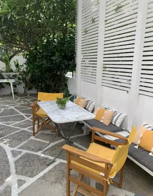 a table and chairs sitting on a patio at Gallery7B in Ialyssos